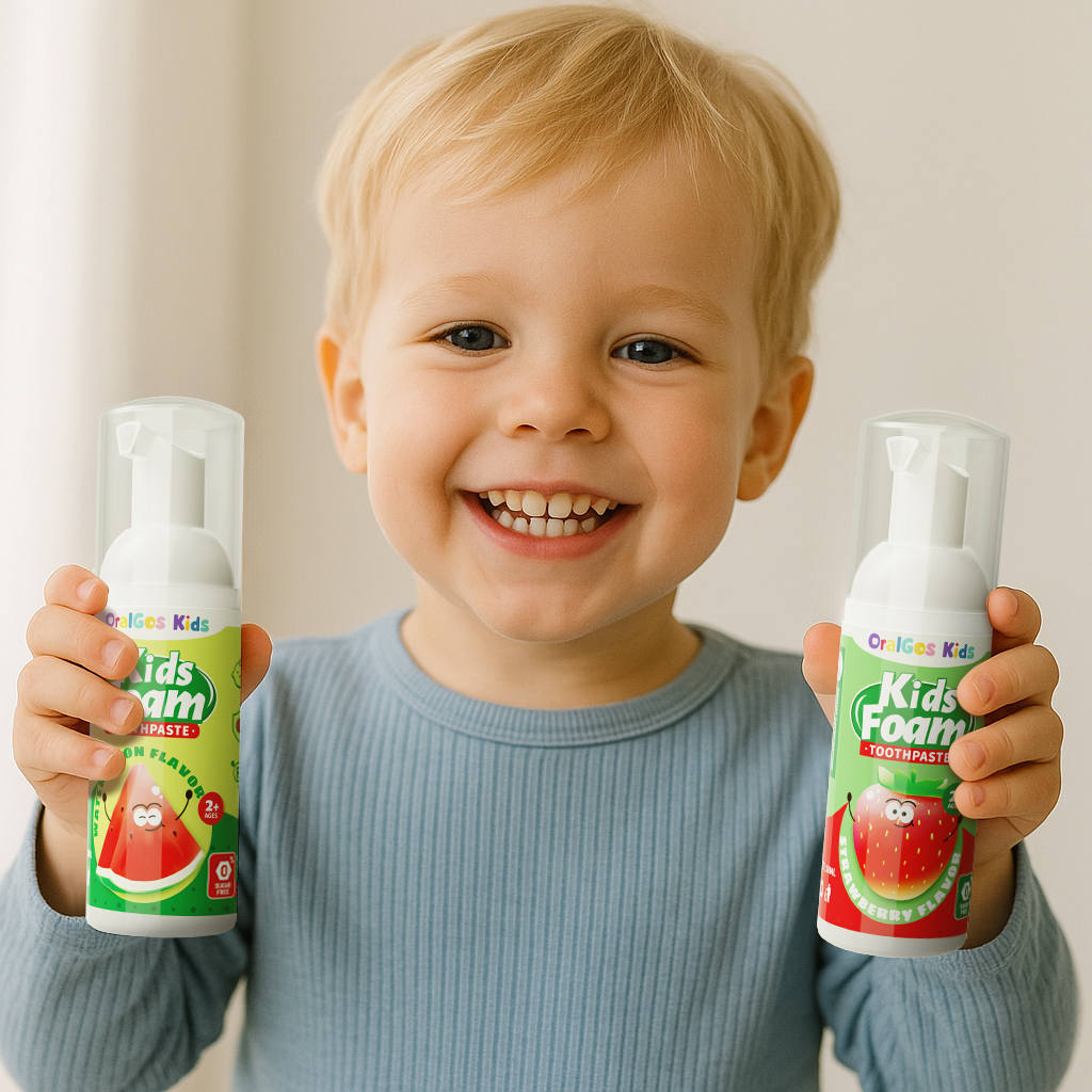 A smiling toddler (age 2–5) holding OralGos Tooth Mousse with both hands